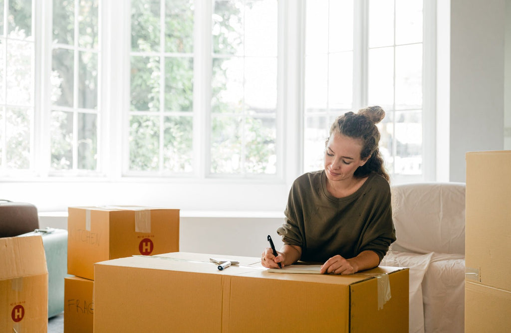 A woman packing boxes to move house