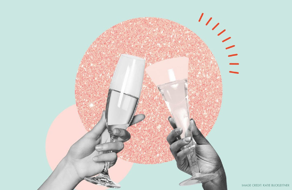 Two hands clinking champagne glasses to celebrate Galentine's Day