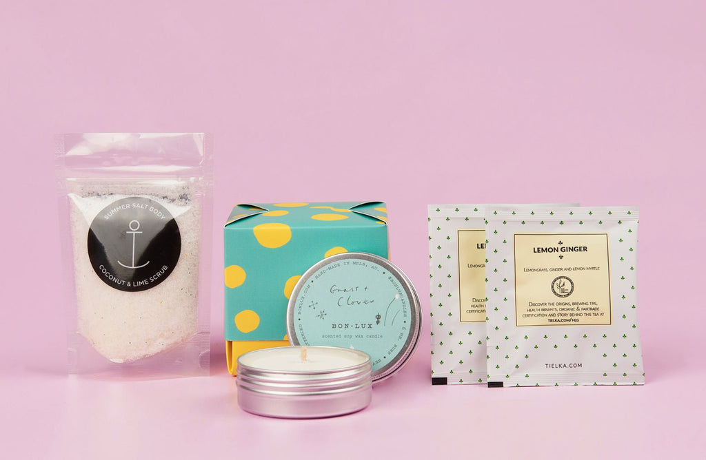 Gift box including body scrub, a candle and tea bags